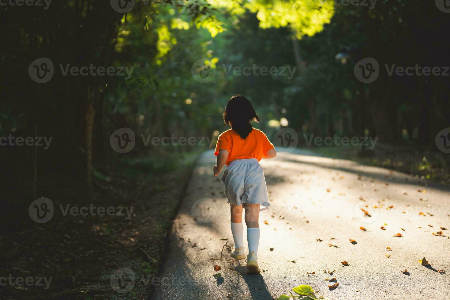 Happy baby asian girl smiling. little girl running and smiling at sunset happy baby girl smiling. little baby running at sunset. cute baby running at playground garden. photo