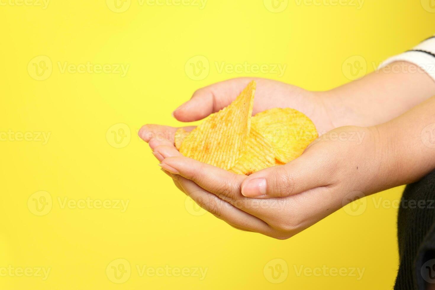 Hand with Potato Chips photo