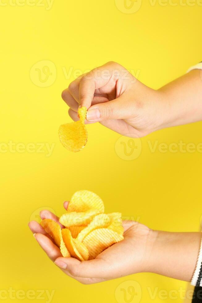 Hand with Potato Chips photo