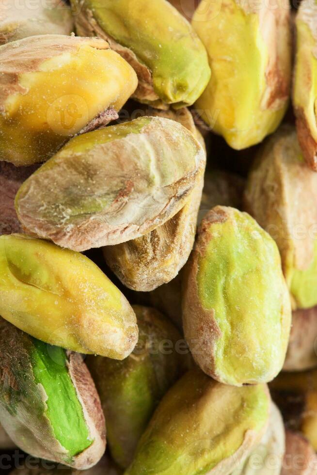 Pistachio nuts. Many pistachios as a background, texture top view photo