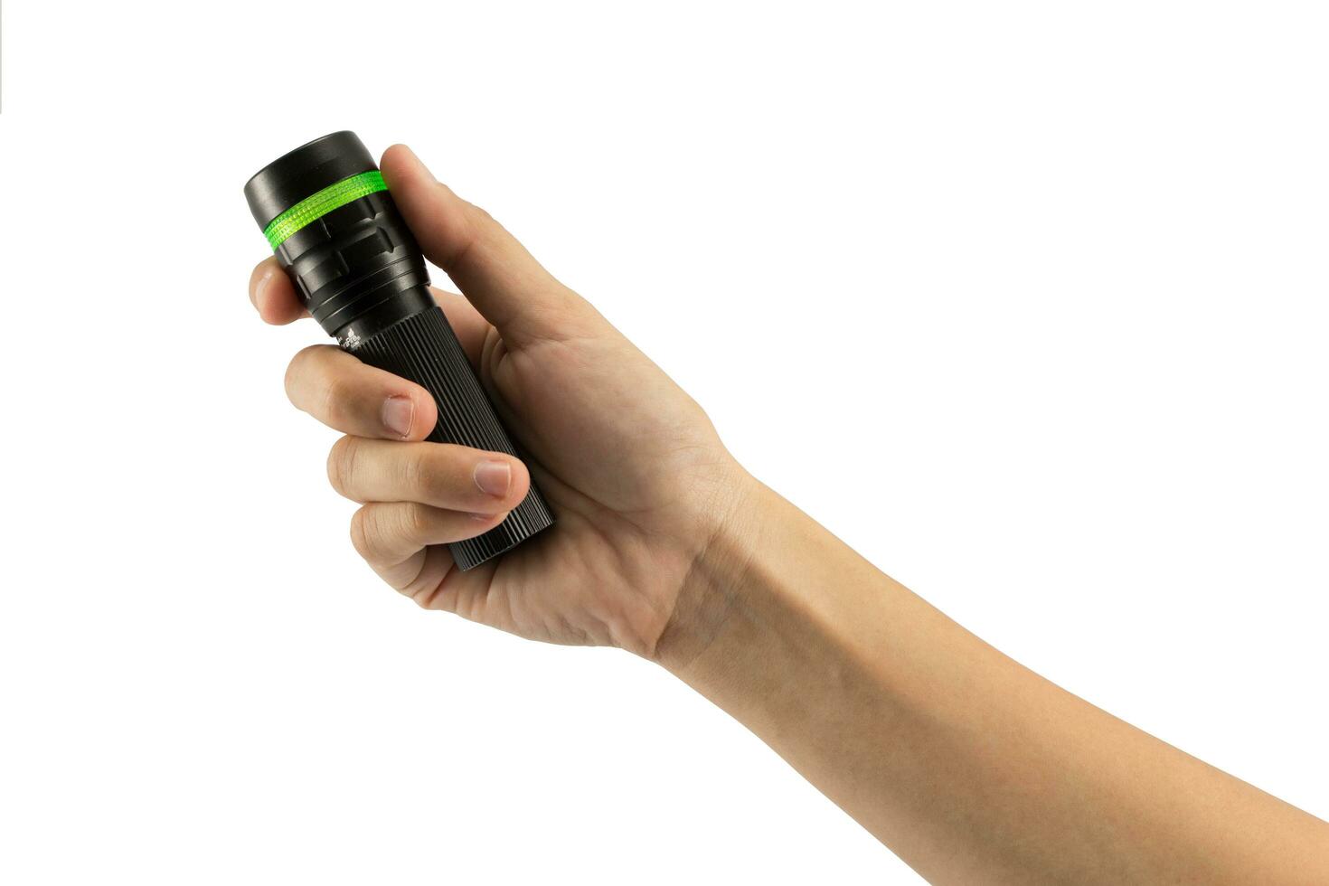 Hand-hold black Flashlight torch shines light lighting up an isolated white. object emergency electric tool energy lamp lantern led battery power for security search or direction view finding in dark. photo