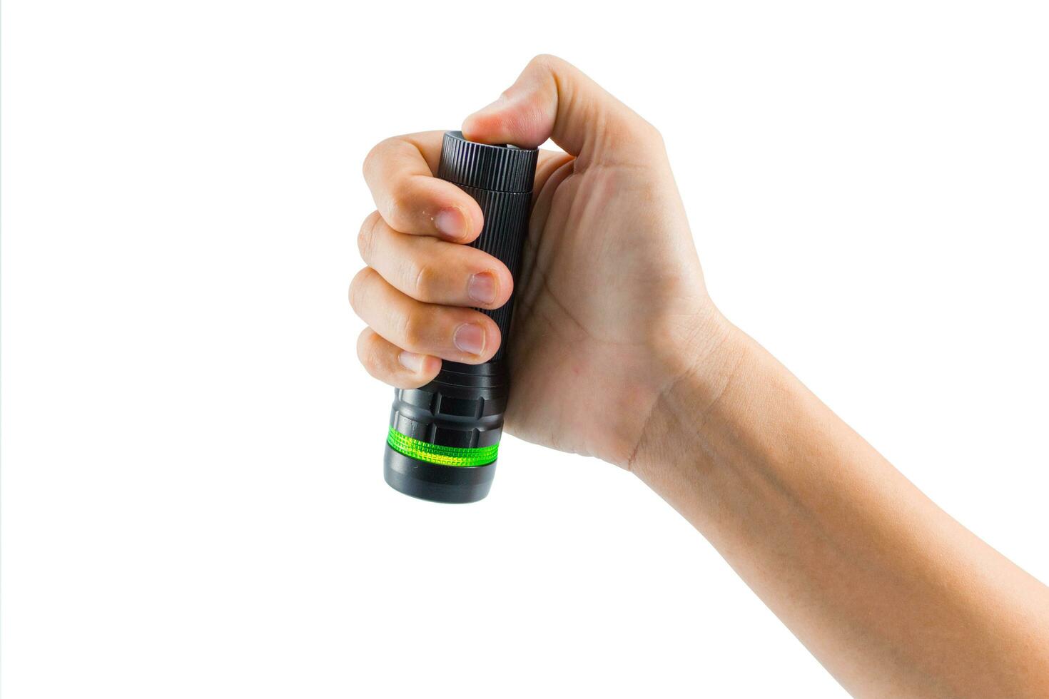 Hand-hold black Flashlight torch shines light lighting up an isolated white. object emergency electric tool energy lamp lantern led battery power for security search or direction view finding in dark. photo