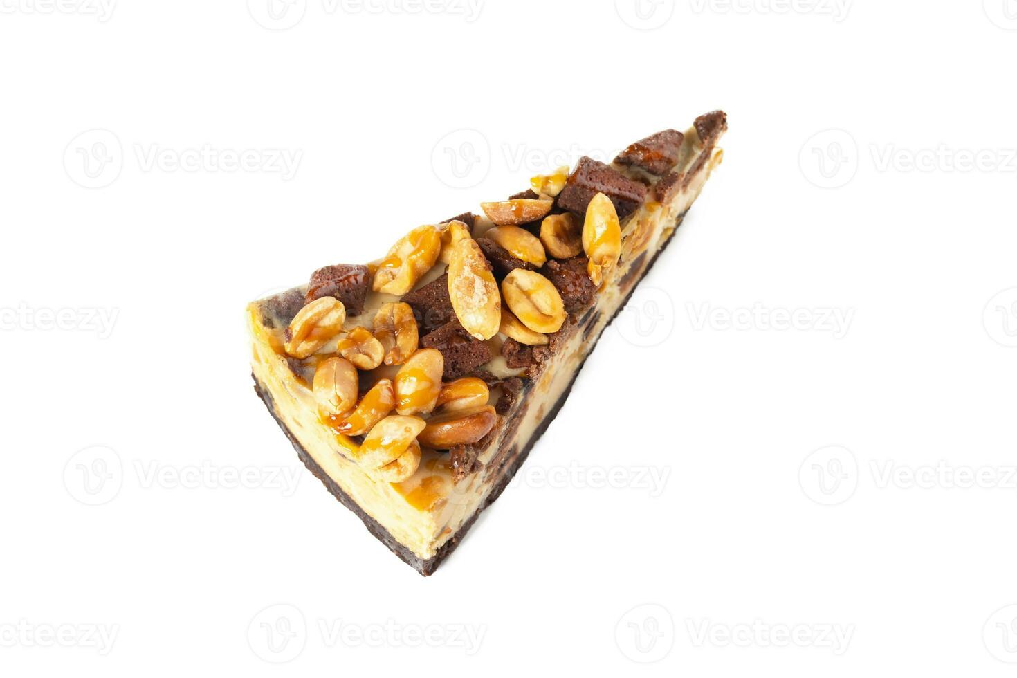 Slice of cheesecake caramel with peanuts and cookies top view on white background isolated photo