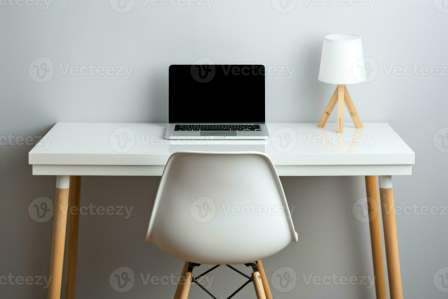 Table for working at a computer. Workplace at home.Desk with laptop, desk lamp and chair. Side view photo