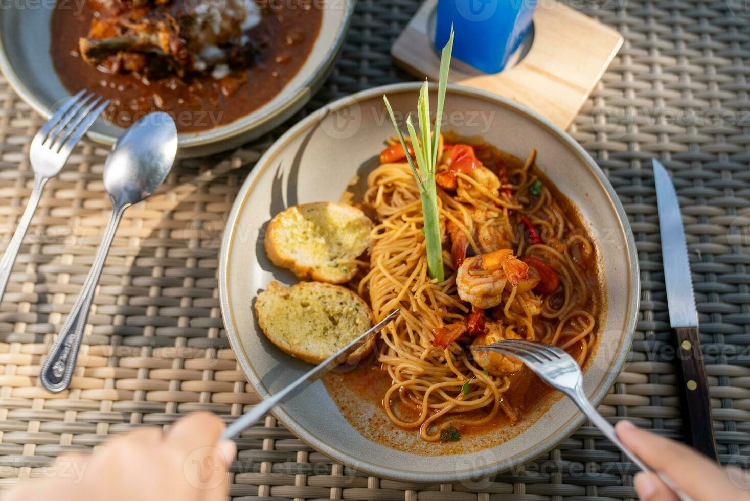 Spaghetti, pizza, french fries, beef steak on a wooden plate on the beach photo
