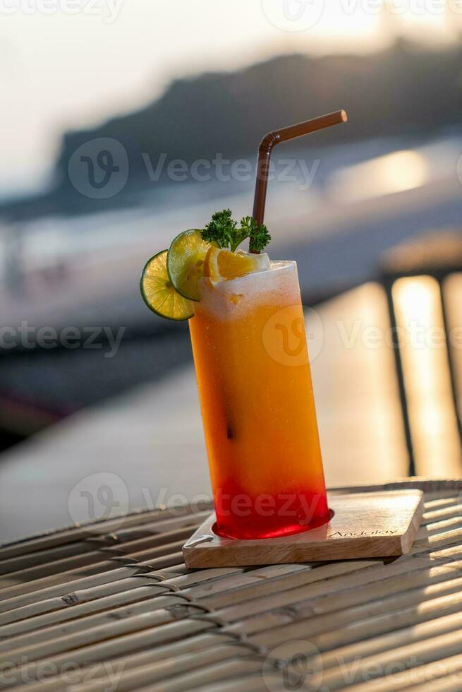Colorful cocktails in pretty glasses on the beach photo