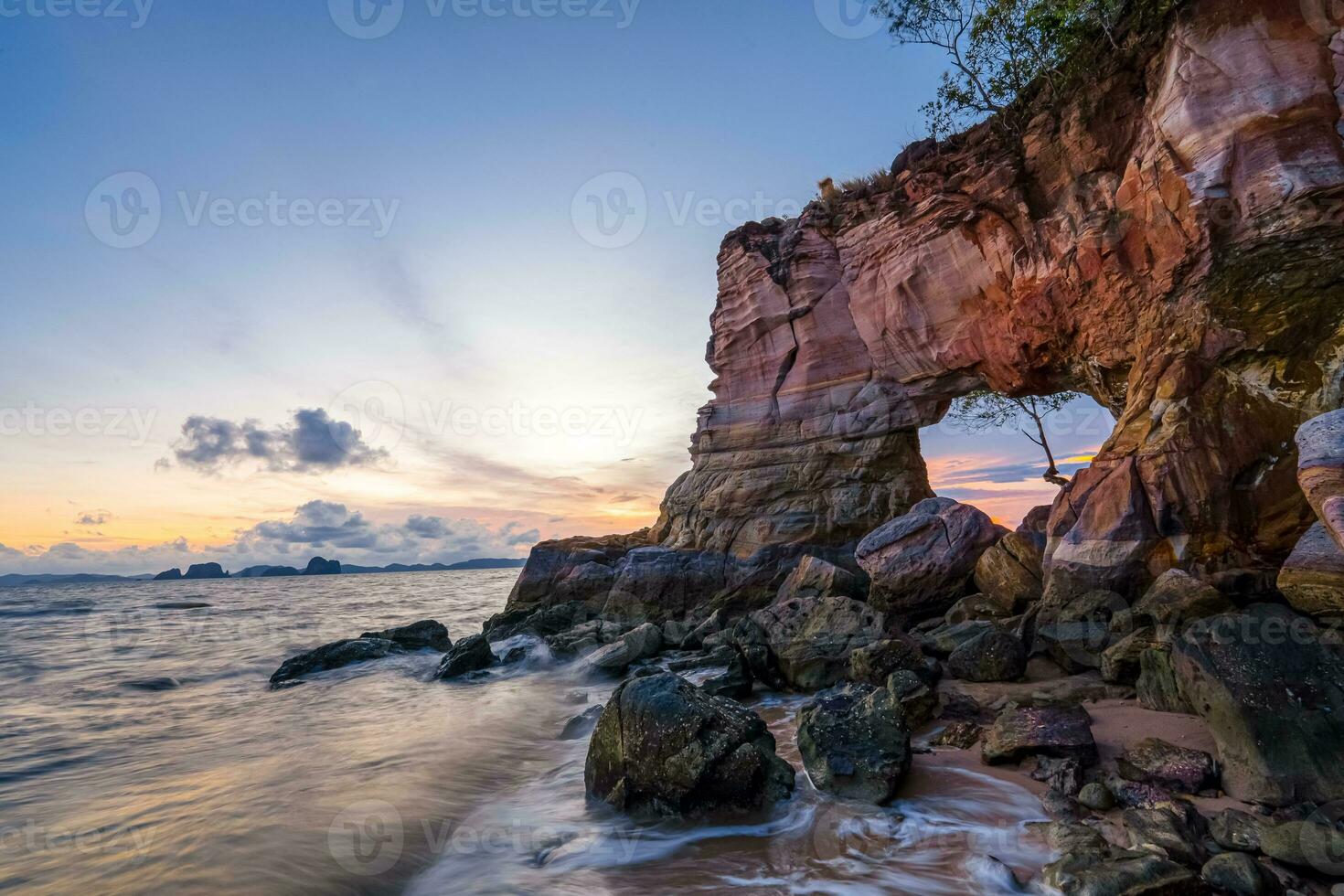 Buffalo Nose Cape, Ao Tha Len, Krabi Province, Thailand, rocky cliff with a hole through which you can pass through. It looks like an elephant's trunk. Sunset time is very beautiful. photo