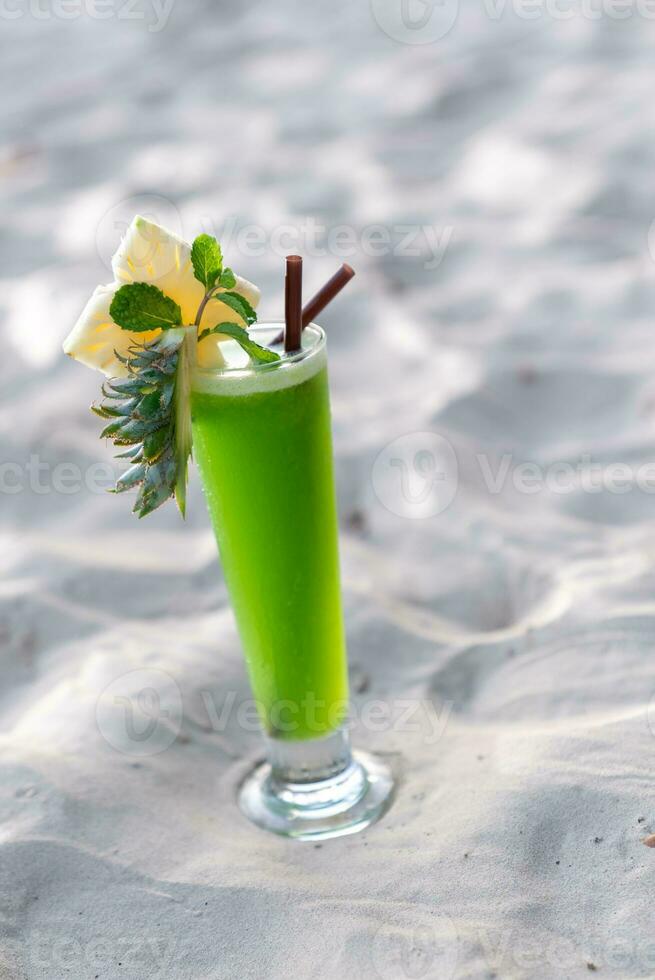 Colorful cocktails in pretty glasses on the beach photo