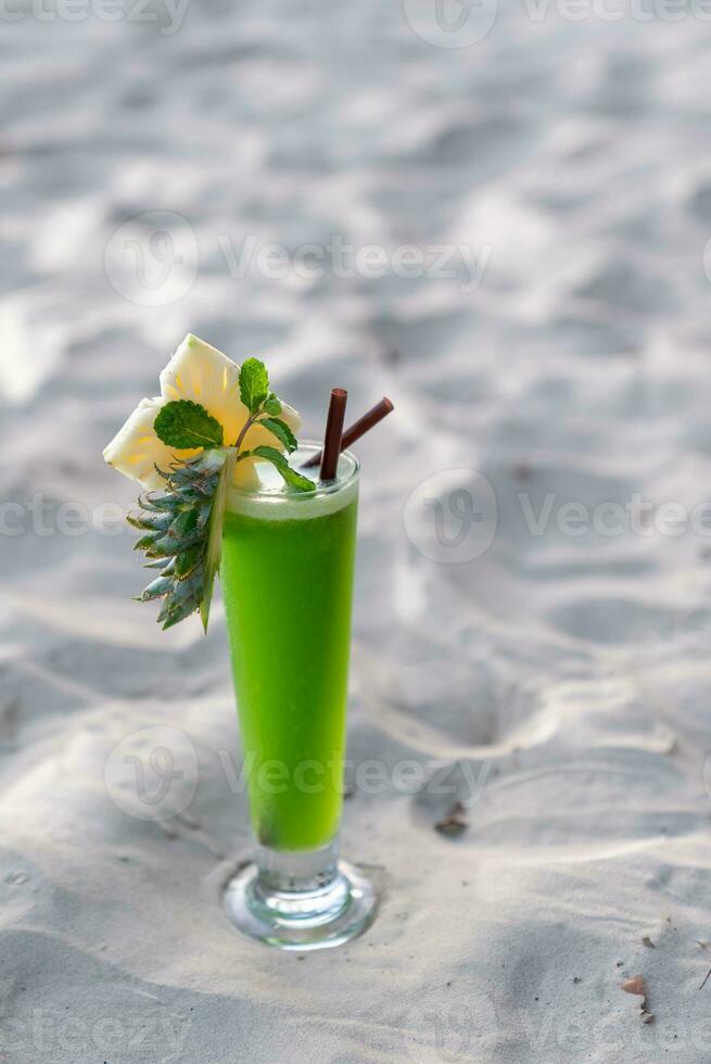 Colorful cocktails in pretty glasses on the beach photo