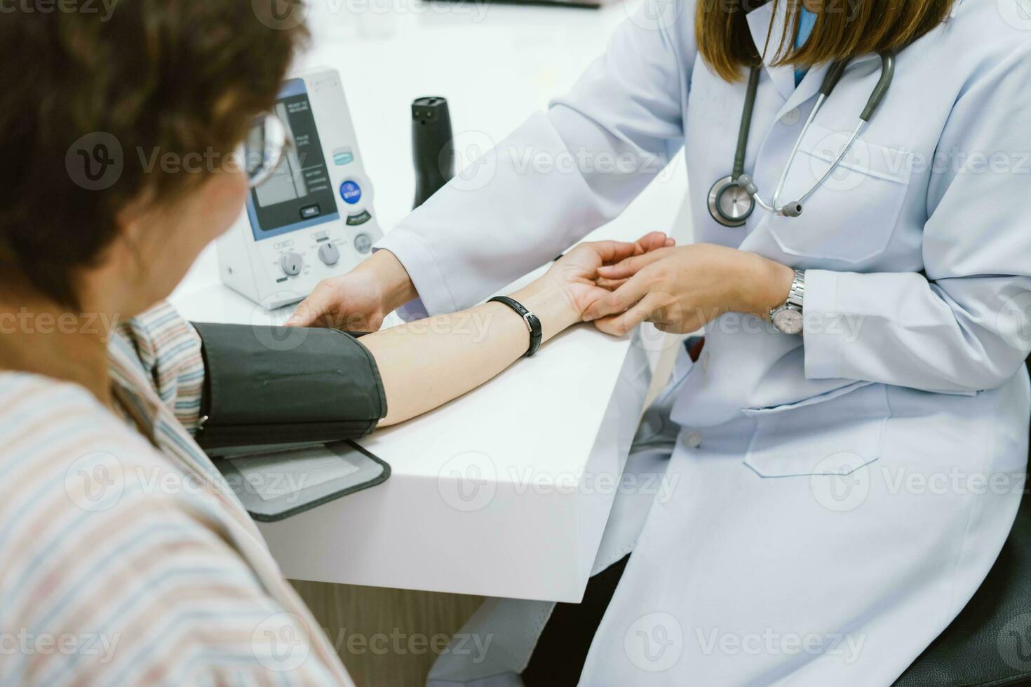 close up doctor checking senior patient blood pressure. Health care. photo