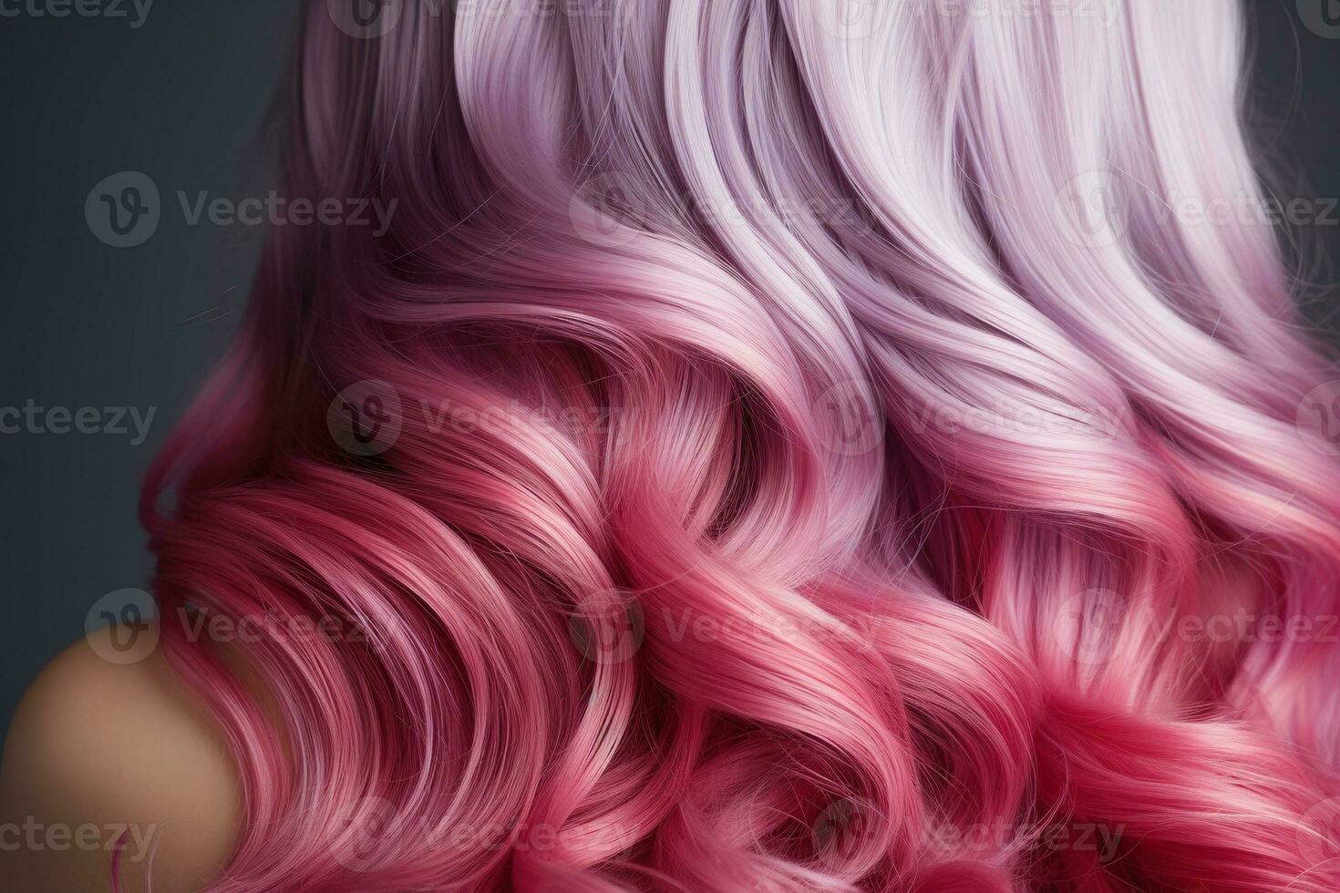 Pink hair close-up. Women's long pink hair. Beautiful styling of wavy shiny curls. Hair coloring. Hairdressing treatments photo