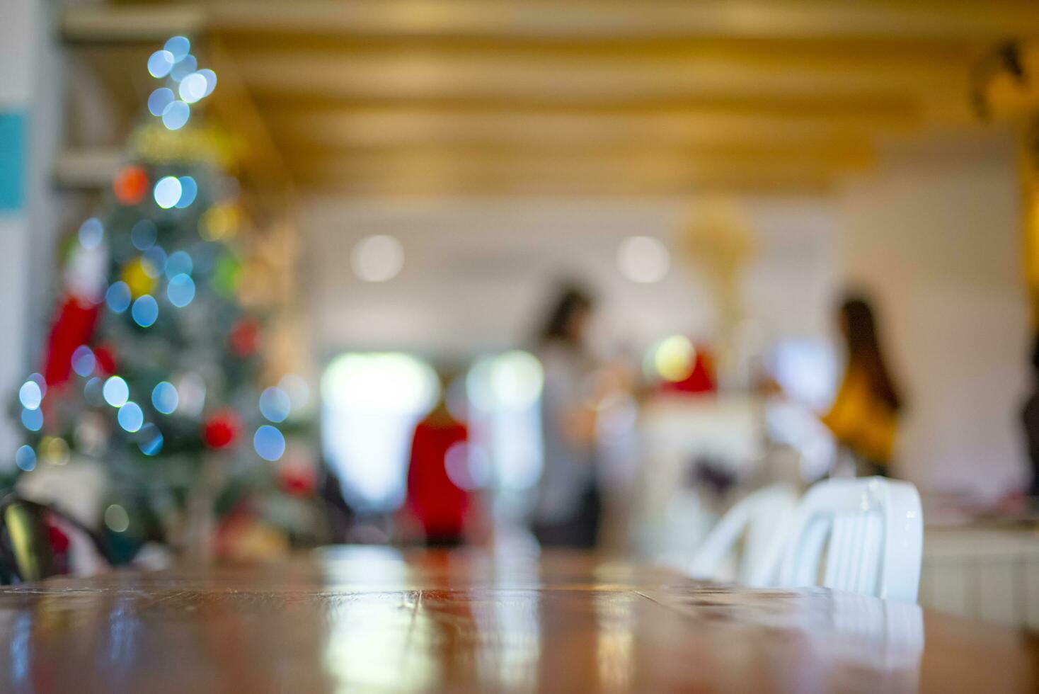 Abstract colorful light bokeh background, Glitter defocused abstract in coffee shop, Twinkly Lights with wooden table for background. photo
