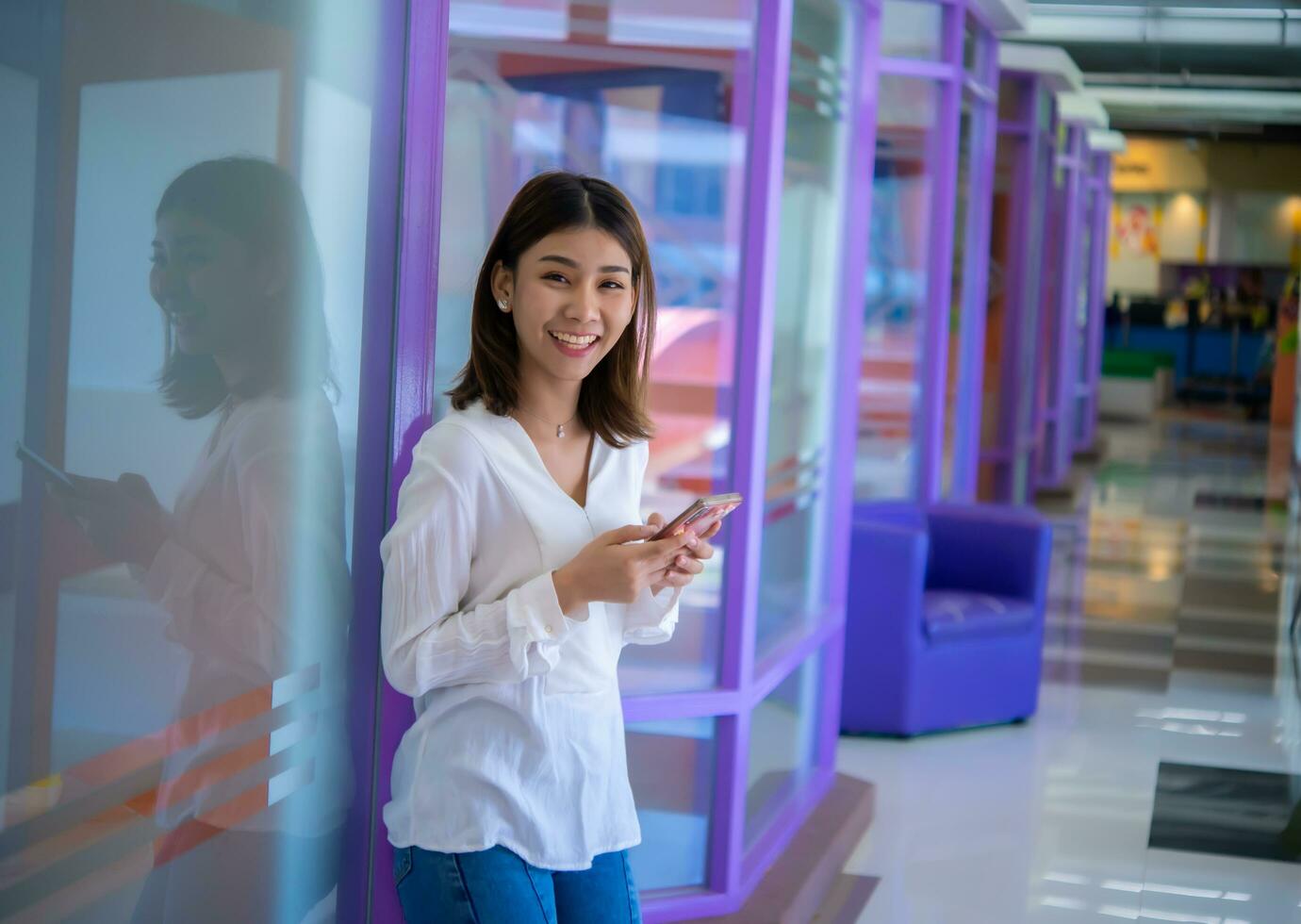 Mobile phone in her hand is a constant reminder of the importance of staying connected in the business world, Digital marketing. photo