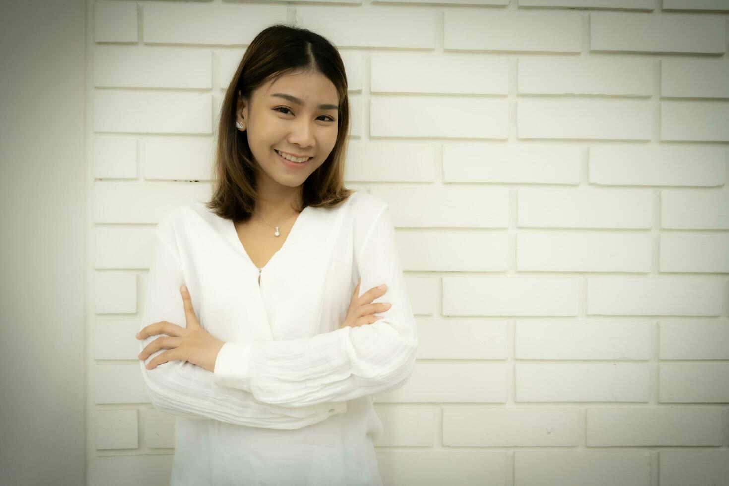 Portrait of a beautiful business woman in a close-up shot is standing with arms crossed and looking at the camera with smile on her face, Copy space. photo