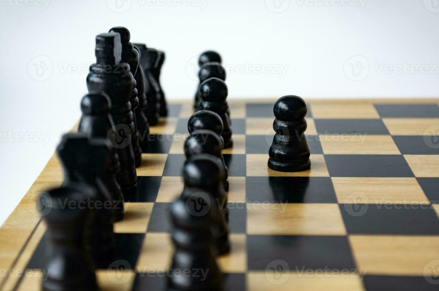 Selective view of wooden white pawn moving toward for battle. Strategy and tactic concept photo