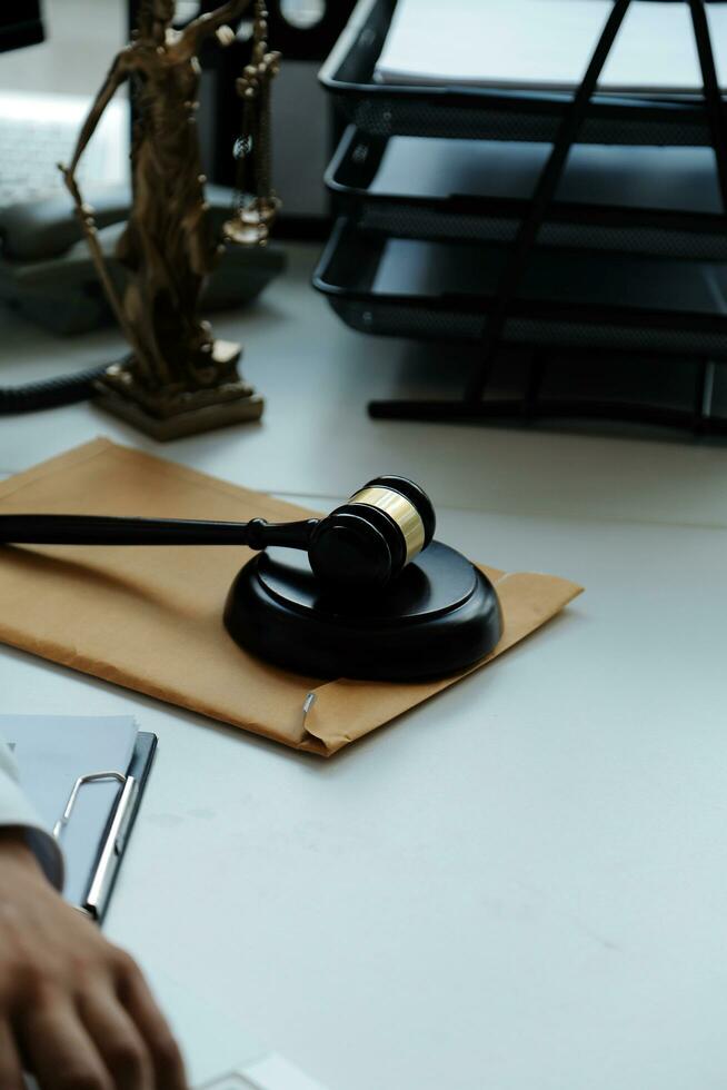 Judge gavel with Justice lawyers having team meeting at law firm in background. Concepts of law. photo