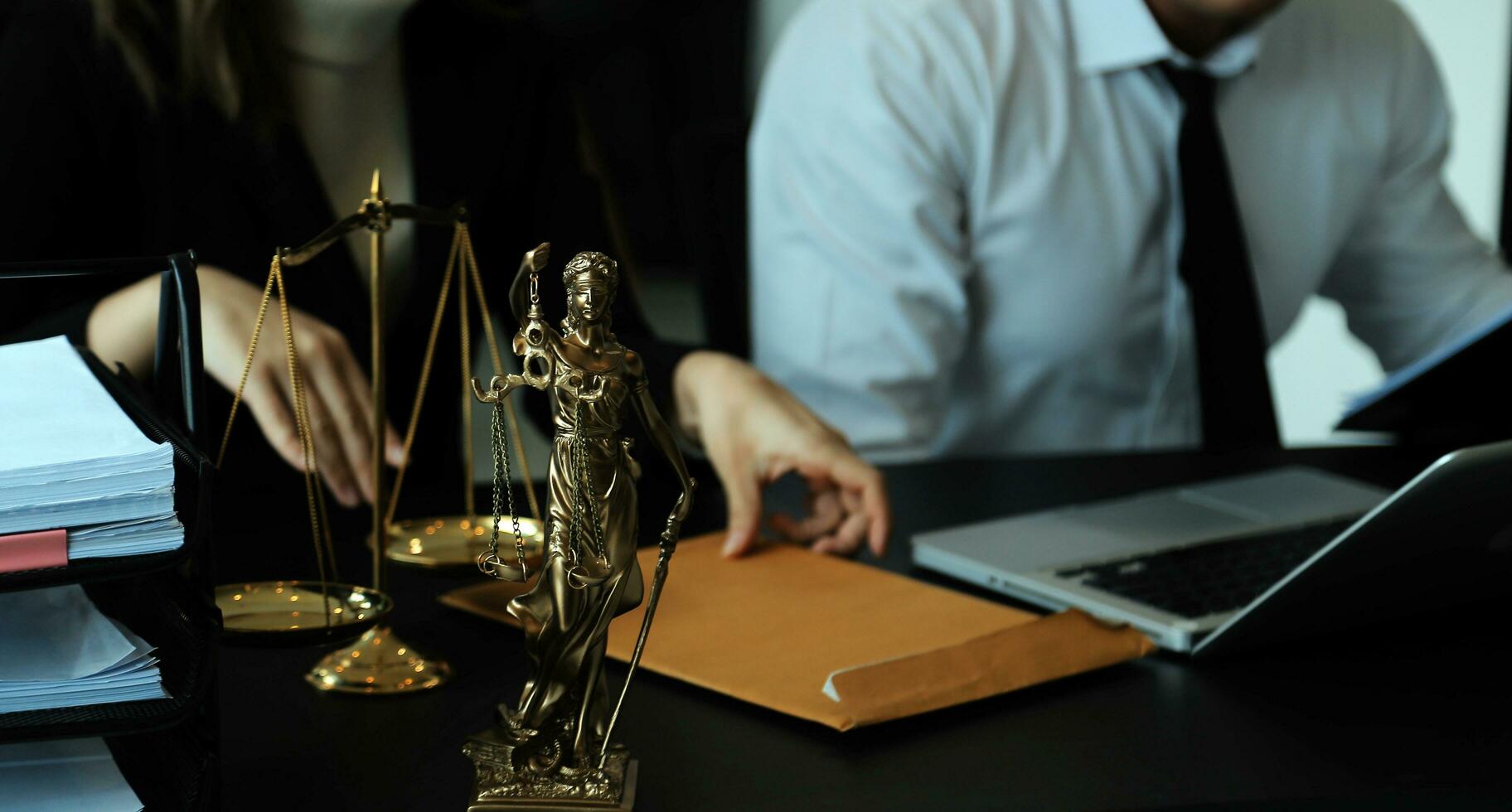 Judge gavel with Justice lawyers having team meeting at law firm in background. Concepts of law. photo