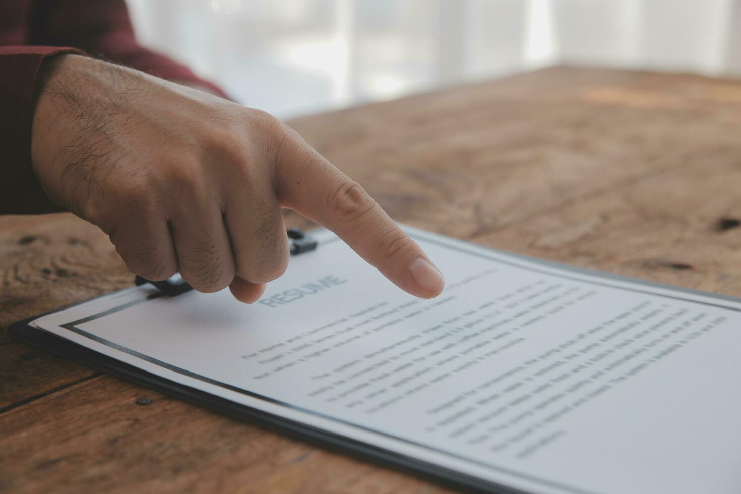 Close up view of job interview in office, focus on resume writing tips, employer reviewing good cv of prepared skilled applicant, recruiter considering application, hr manager making hiring decision photo