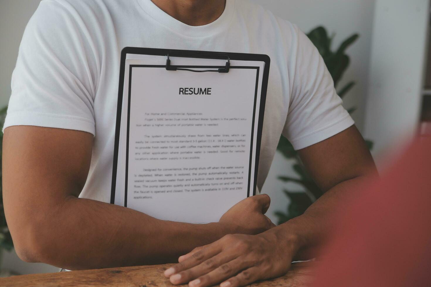 Close up view of job interview in office, focus on resume writing tips, employer reviewing good cv of prepared skilled applicant, recruiter considering application, hr manager making hiring decision photo