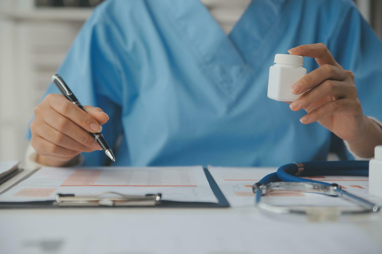 Doctor writing out RX prescription selective focus photo