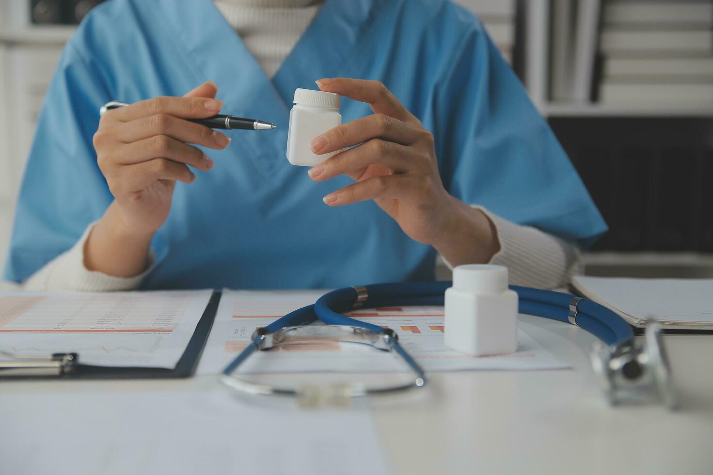 Doctor writing out RX prescription selective focus photo