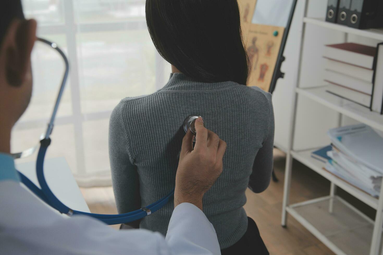 Asian doctor woman visited patient woman to diagnosis and check up health at home or private hospital. Female patient explain health problem and symptoms to doctor .Health care premium service at home photo