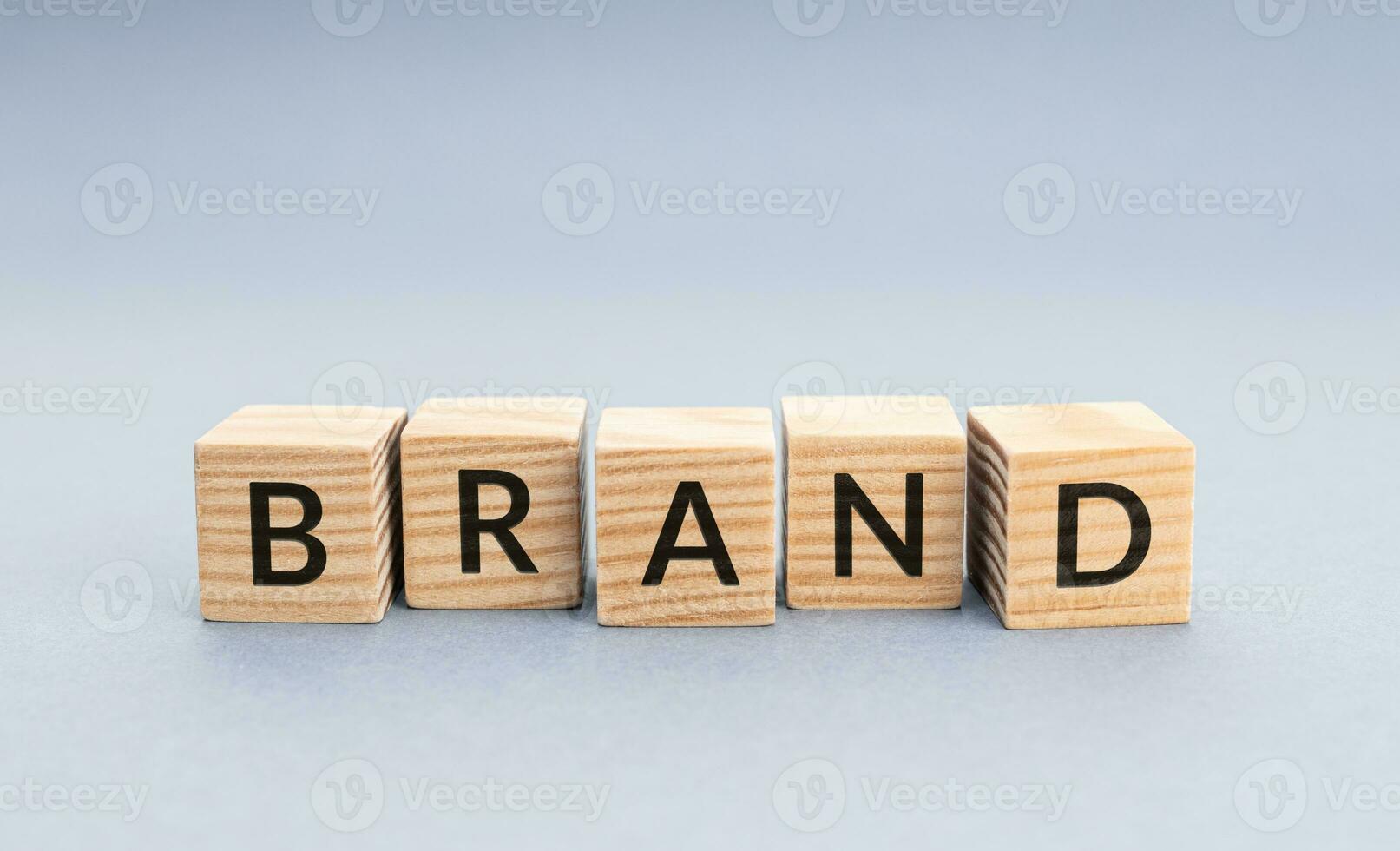 BRAND word on wooden blocks. Gray background with Copy space photo