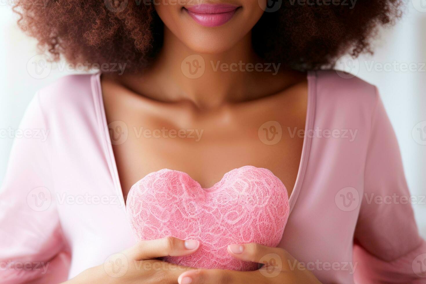 Pink October - Woman wearing a pink top and holding a pink heart in support of breast cancer awareness. International awareness movement for the early detection of breast cancer. Generated by AI photo