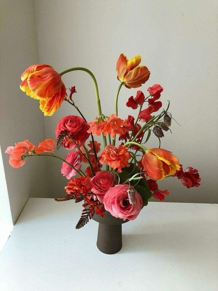 A vase with flowers on a table photo