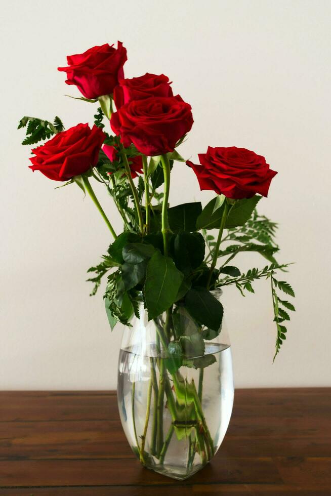 A vase of red roses photo
