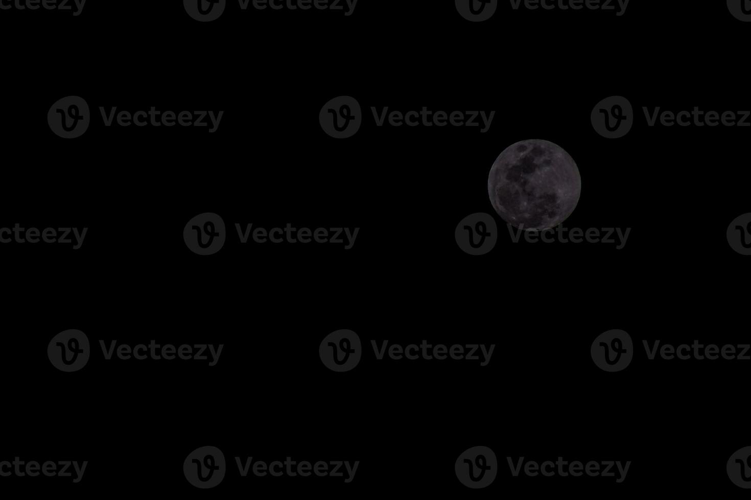 the moon is seen in the dark sky photo