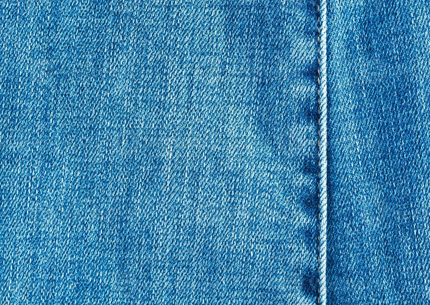 Texture and seam of denim fabric photo