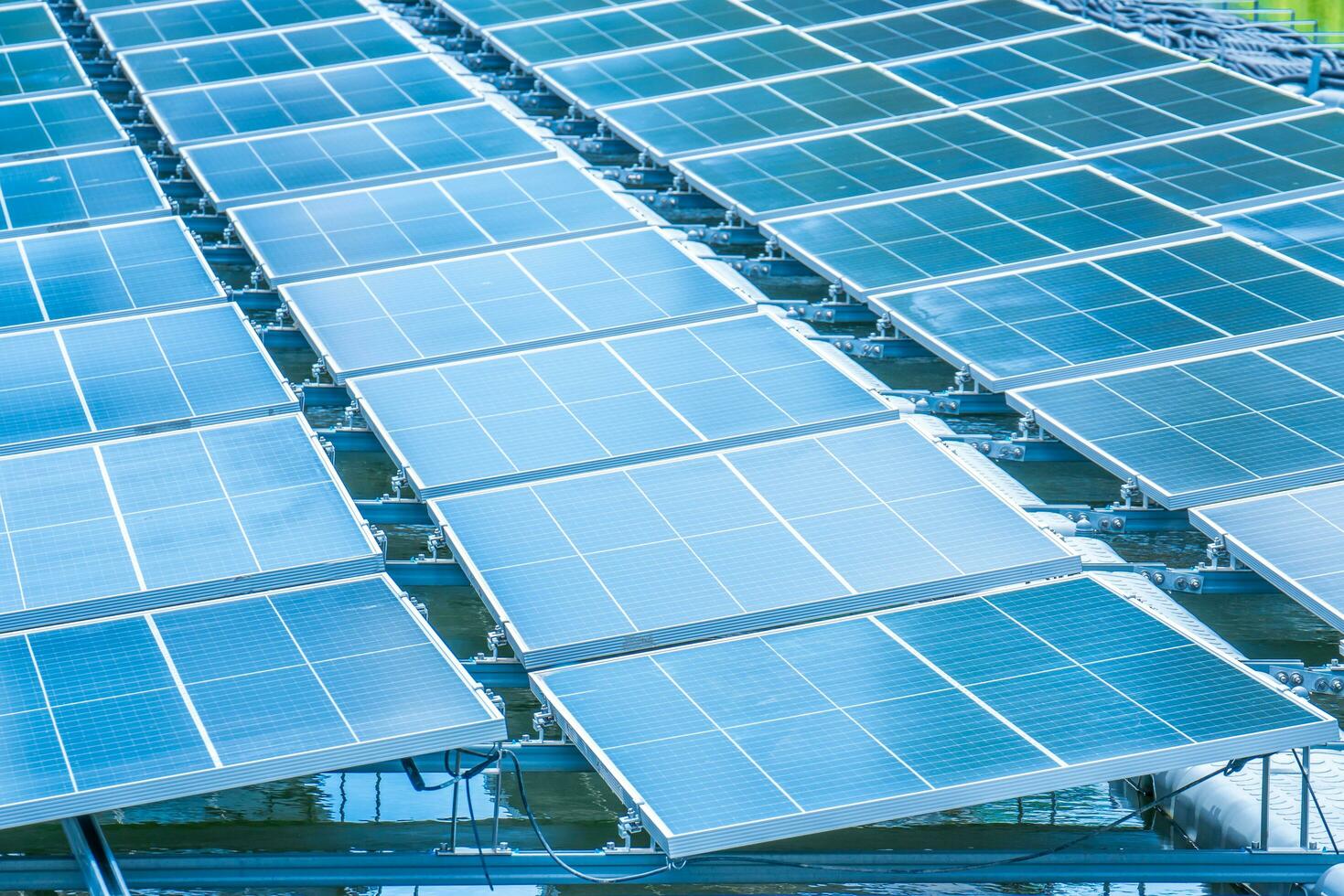 Side view of solar panels floating on water in a lake, for generating electricity from sunlight, selective focus, soft focus. photo