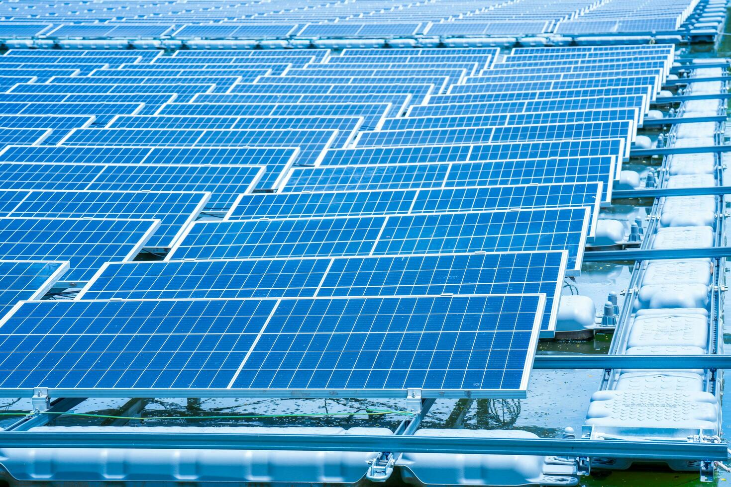 Side view of solar panels floating on water in a lake, for generating electricity from sunlight, selective focus, soft focus. photo