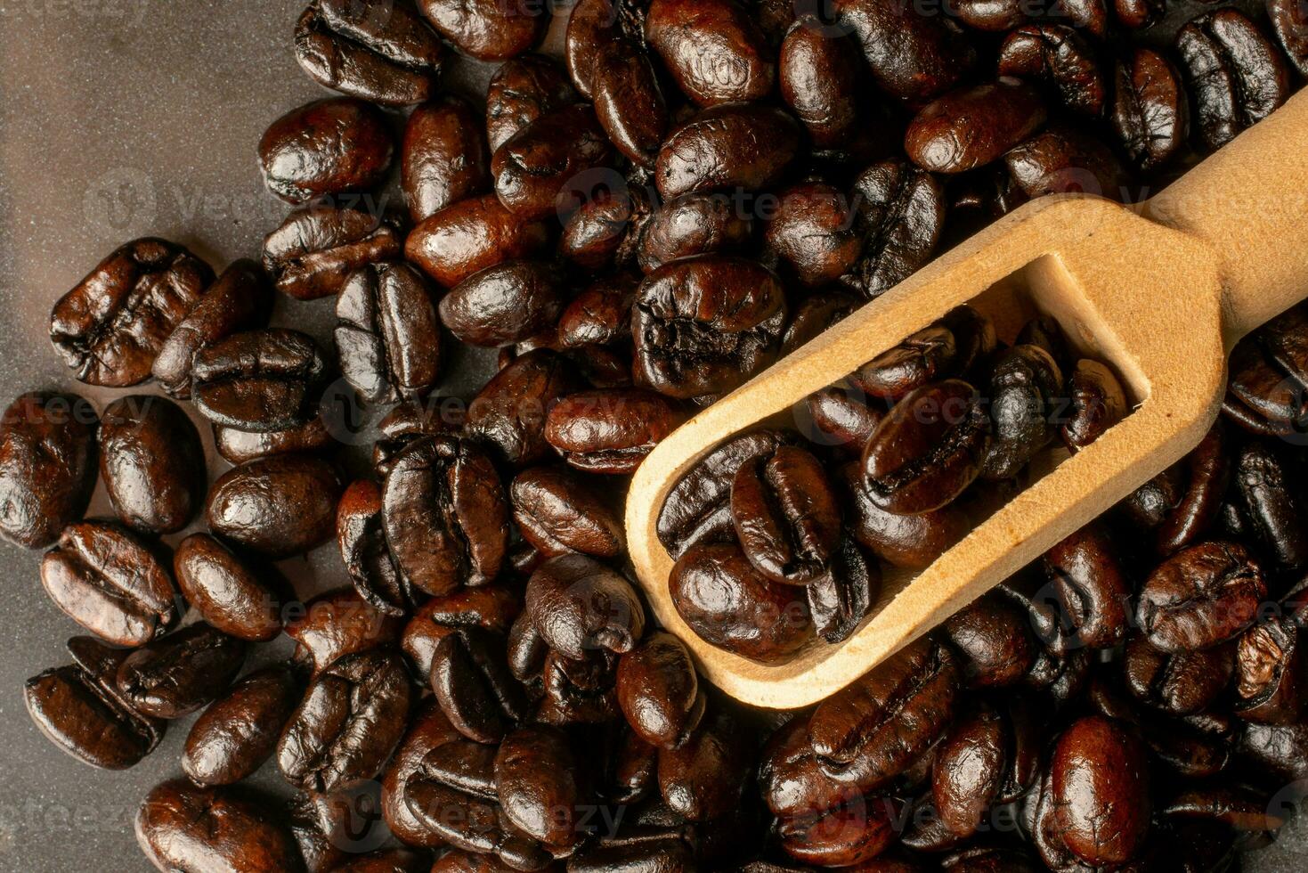 Dark roast coffee beans on a black background photo