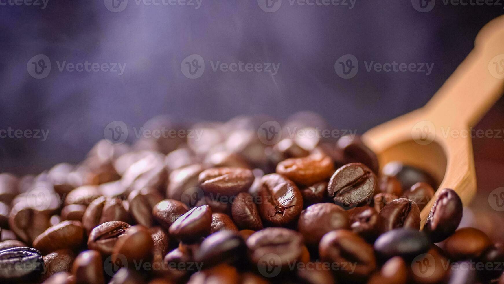Coffee beans roasting with smoke,  selective focus, and soft focus. photo