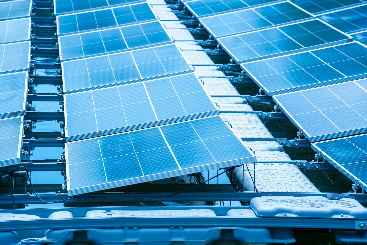 Side view of solar panels floating on water in a lake, for generating electricity from sunlight, selective focus, soft focus. photo