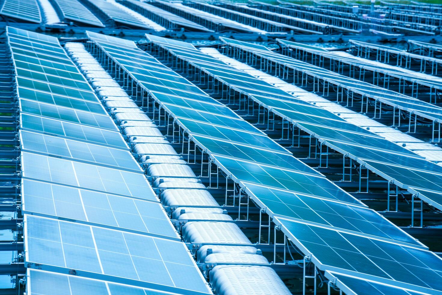 Side view of solar panels floating on water in a lake, for generating electricity from sunlight, selective focus, soft focus. photo