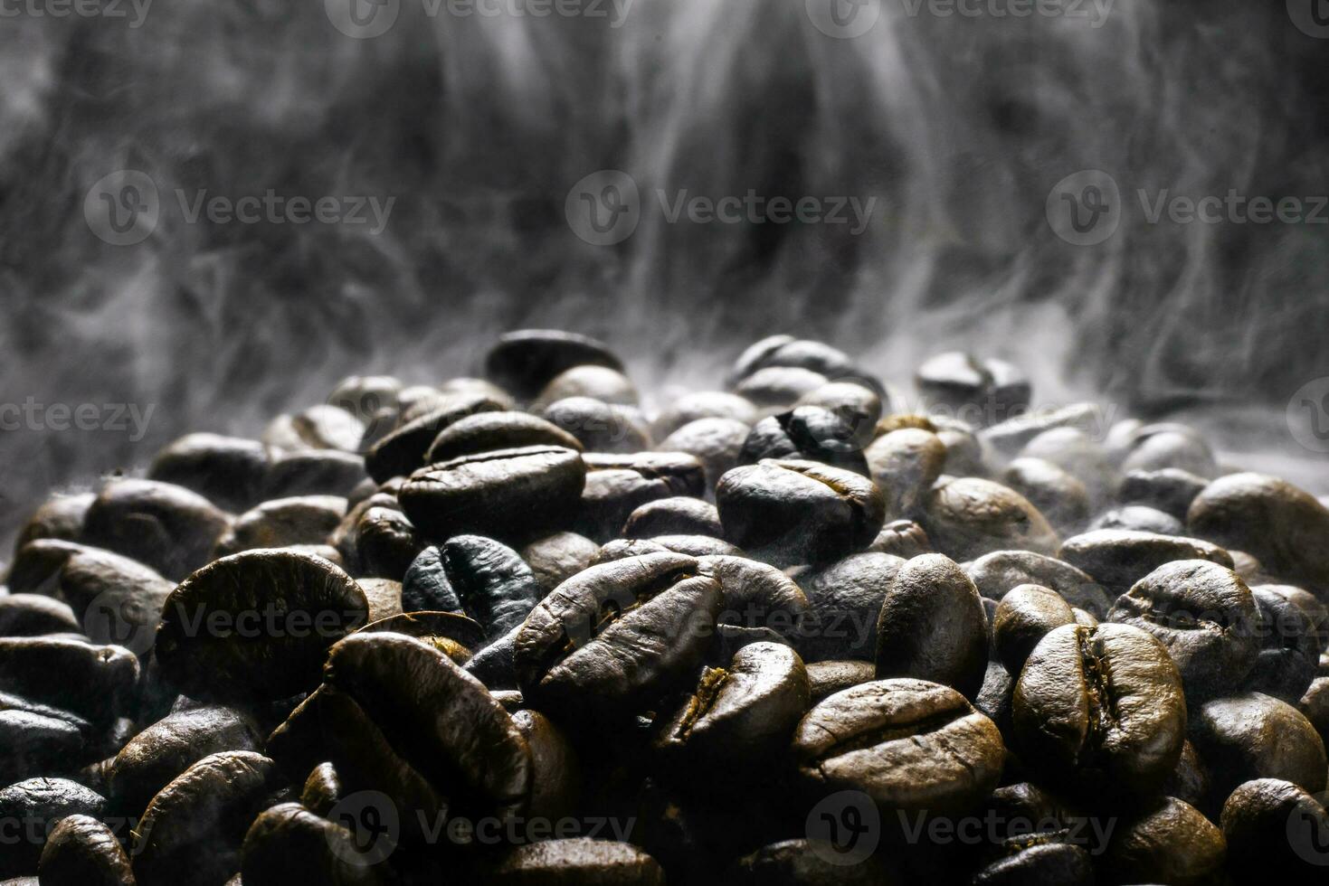 Coffee beans roasting with smoke,  selective focus, and soft focus. photo