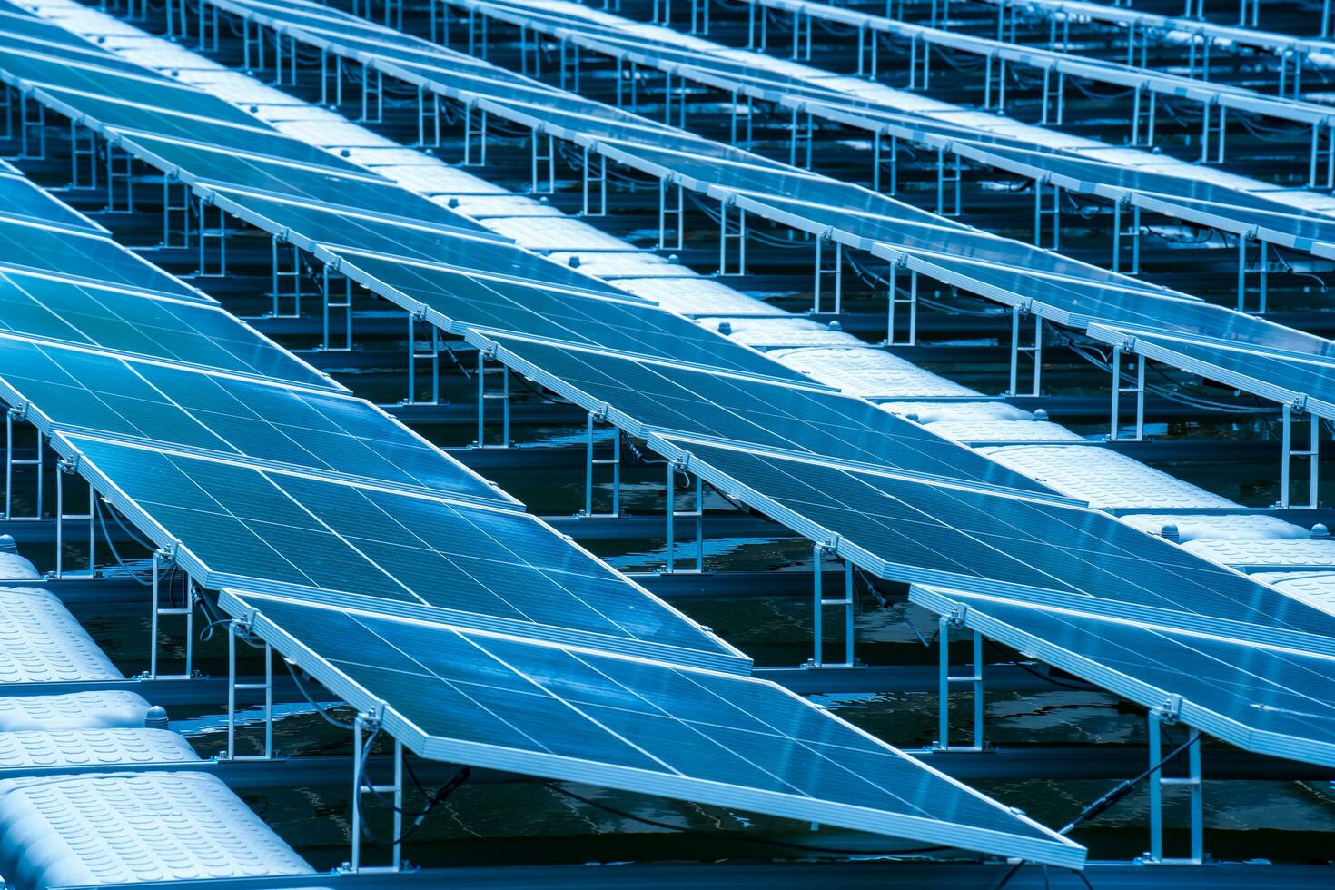 Side view of solar panels floating on water in a lake, for generating electricity from sunlight, selective focus, soft focus. photo