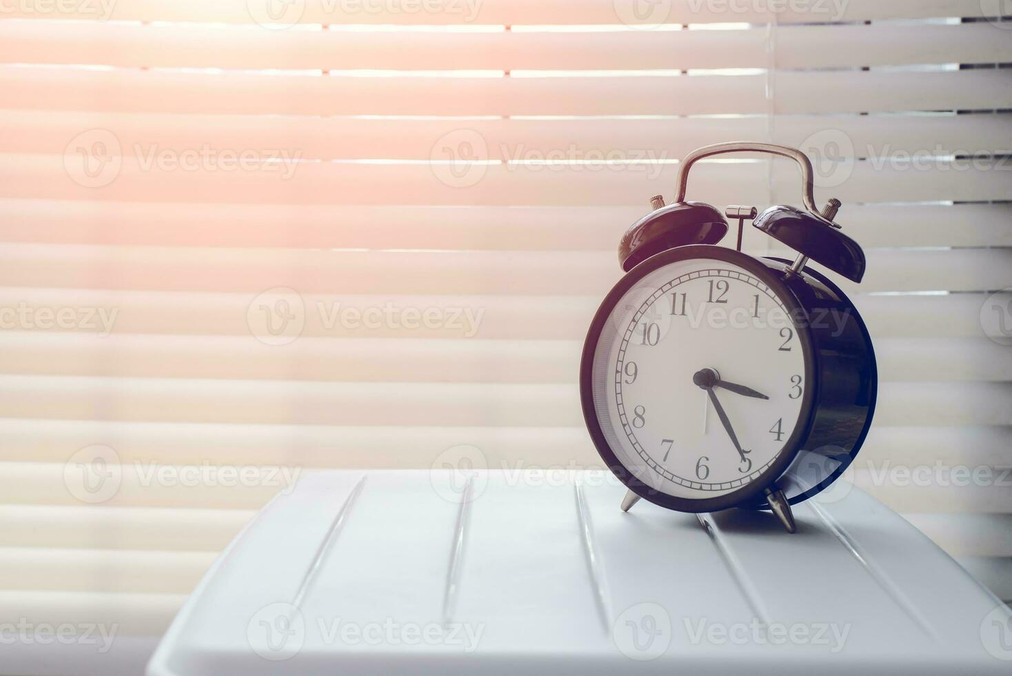 Close up alarm clock at the window area photo