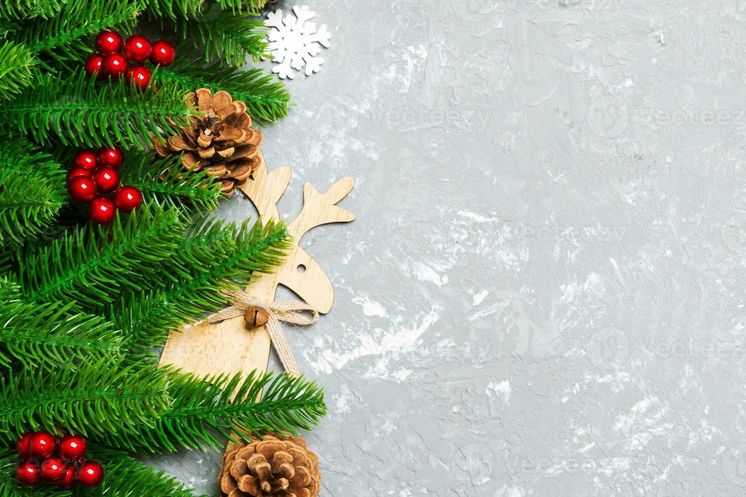 Top view of Christmas background made of fir tree and decorations on cement background. New year holiday concept with copy space photo