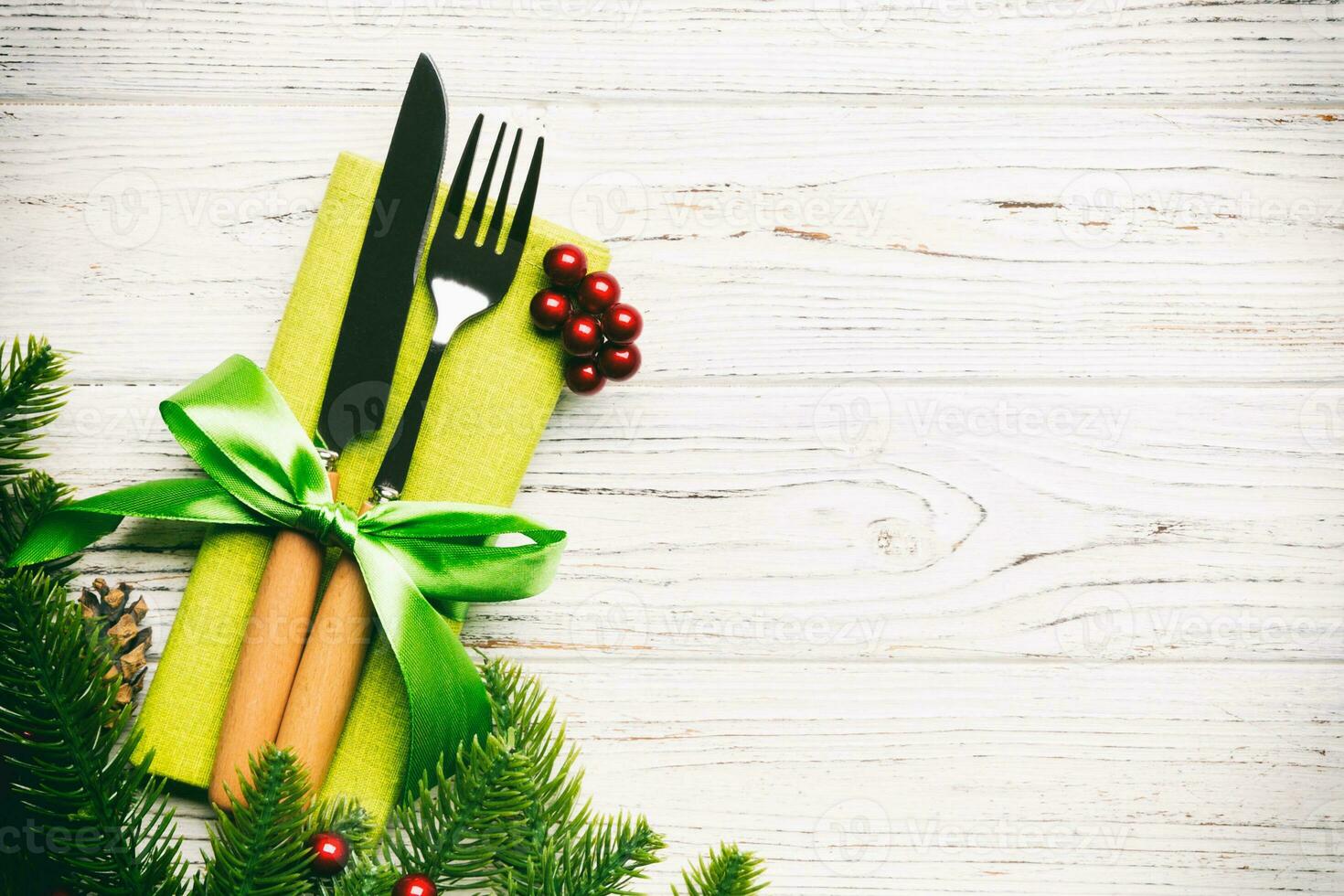 Top view of festive cutlery on new year wooden background. Christmas decorations with empty space for your design. Holiday dinner concept photo