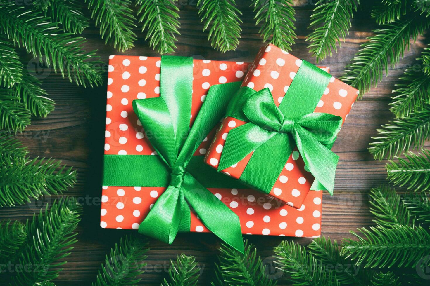 Top view of gifts box decorated with a frame made of fir tree on wooden background. New Year present time concept photo