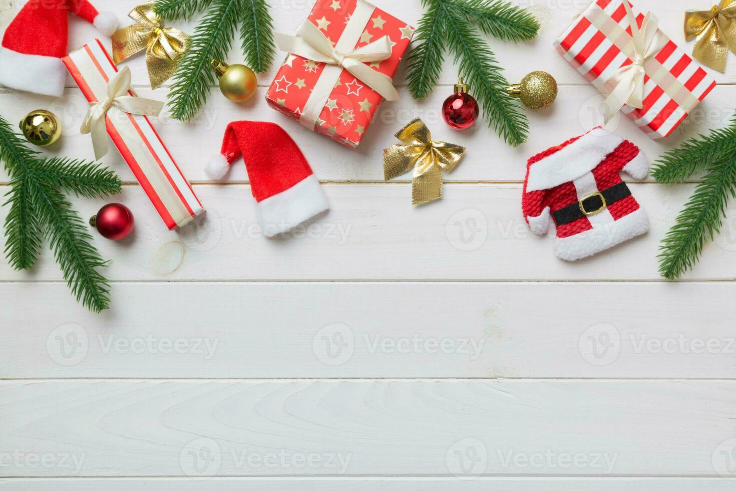 Christmas decorations and fir tree branch and gift boxon dark table. Top view frame with copy space photo