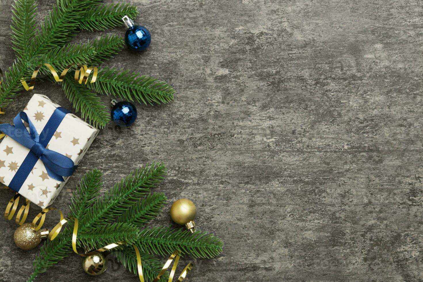Christmas decorations and fir tree branch and gift boxon dark table. Top view frame with copy space photo