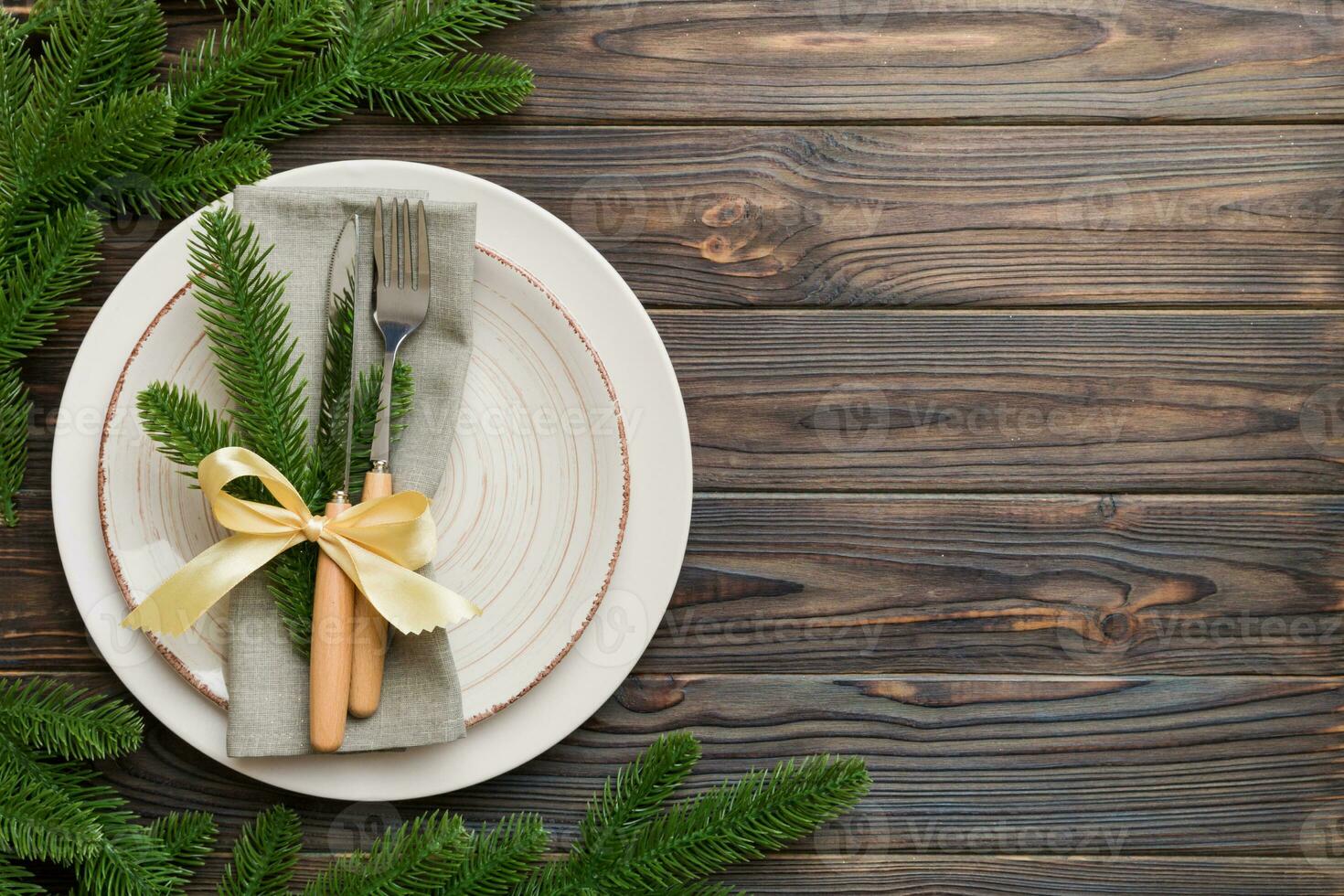 Christmas table place setting with christmas decor and plates, kine, fork and spoon. Christmas holiday background. Top view with copy space photo