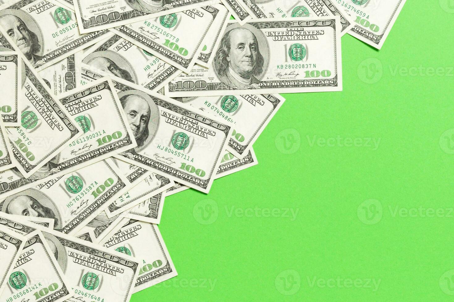 Top view banknotes on colored desk with copy space on top. one hundred dollar bills with stack of money in the middle. Top view of business concept photo