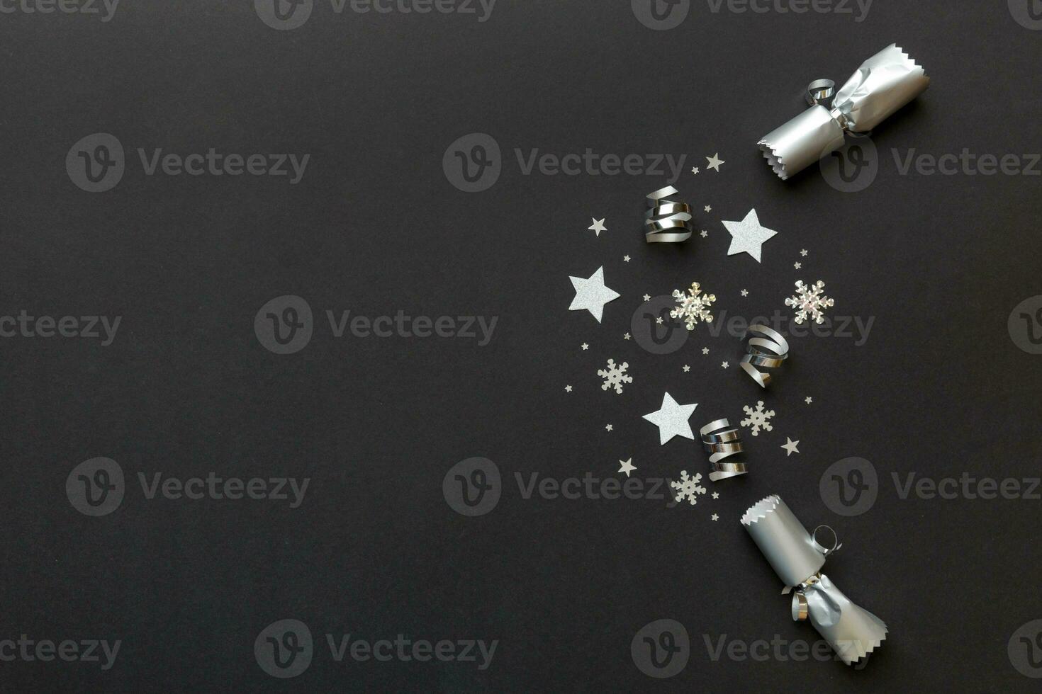 Christmas crackers with shiny confetti on color background, top view, copy space photo
