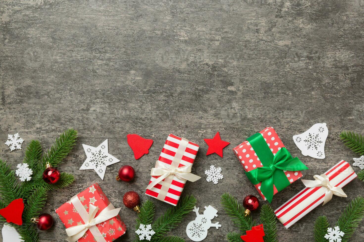 Christmas decorations and fir tree branch and gift boxon dark table. Top view frame with copy space photo